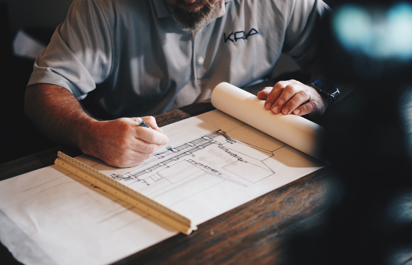 Structural engineer reviewing building design drawings — Structarch Consultants