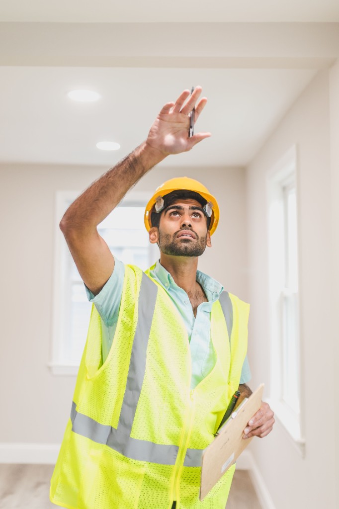 Engineer conducting third-party site inspection with clipboard