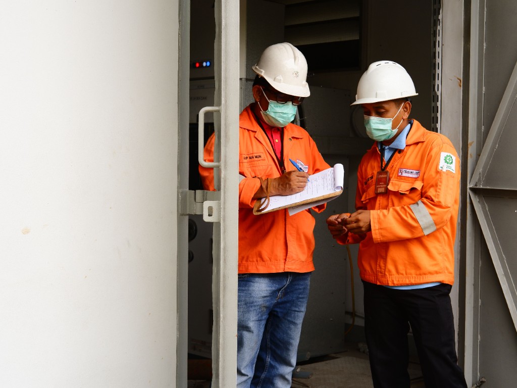 Inspection team reviewing equipment and site records on assignment