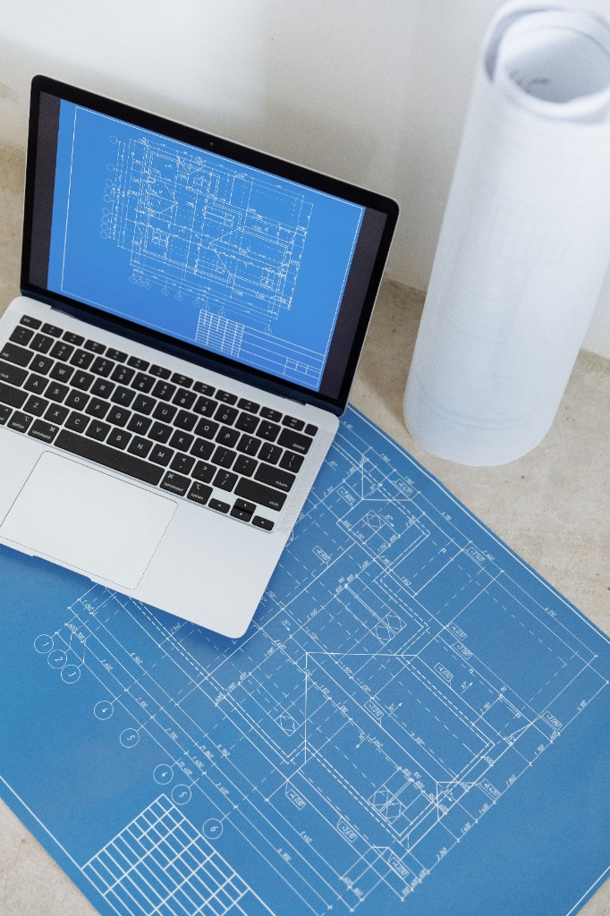Structural blueprints and laptop for design review